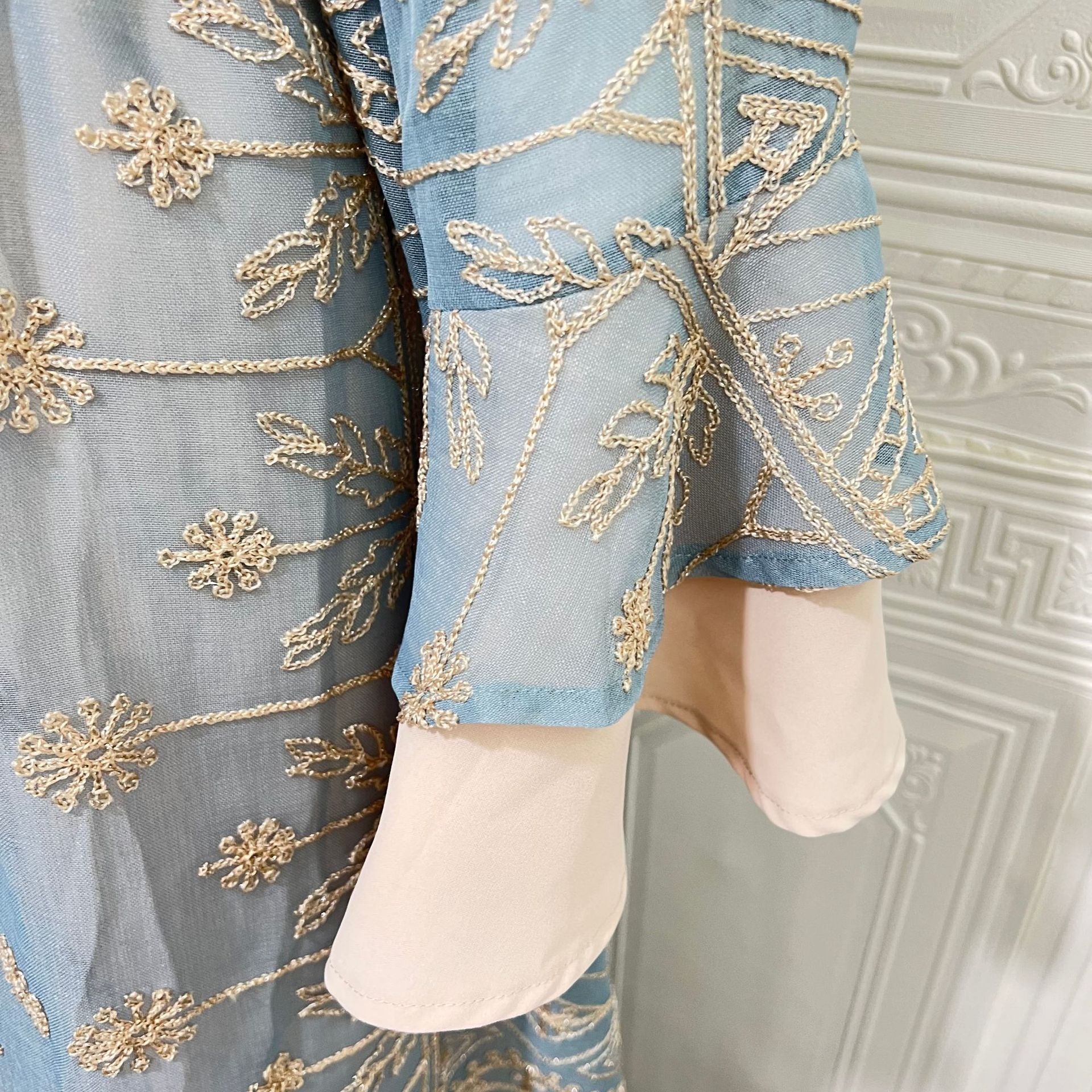 Arabian Pastel Boutique Designer Modest Layered Attire Soft Muted Sky Lightweight Transparent Mesh All Over Vintage Leaf Daisy Thread Motif Mini Stand Neck Self-Tie Waist Belt Double Flared Bell Cuff Sleeves Semi-Sheer Open Front Full Length Outer Ro