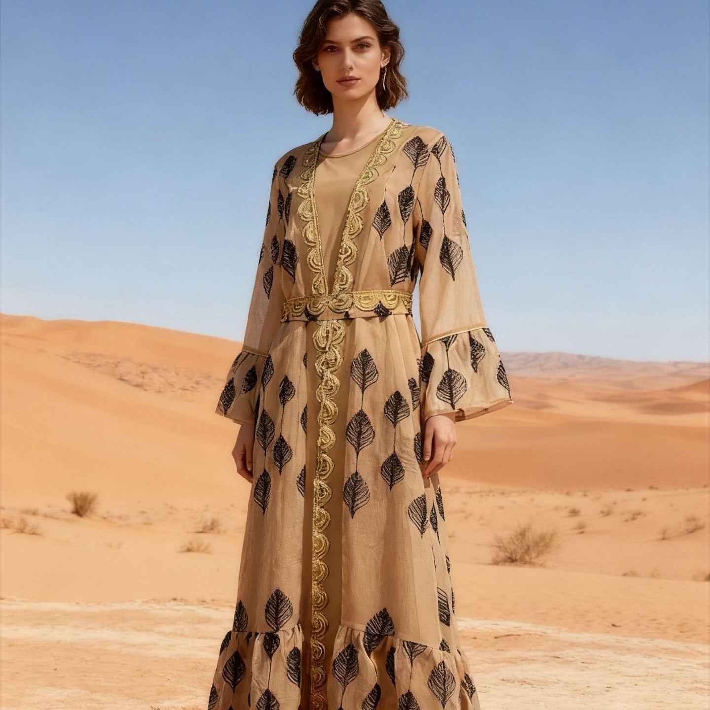 Desert FYP Viral Khaleeji Two-Piece Modest Co-ord Warm Sand Tone Light Woven Outer Kaftan Matching Solid Slip Dress All Over Vintage Black Leaf Print Handcrafted Golden Lace Trim Placket Elastic Gold Waist Belt Bell Flared Tiered Long Sleeve Ruffled