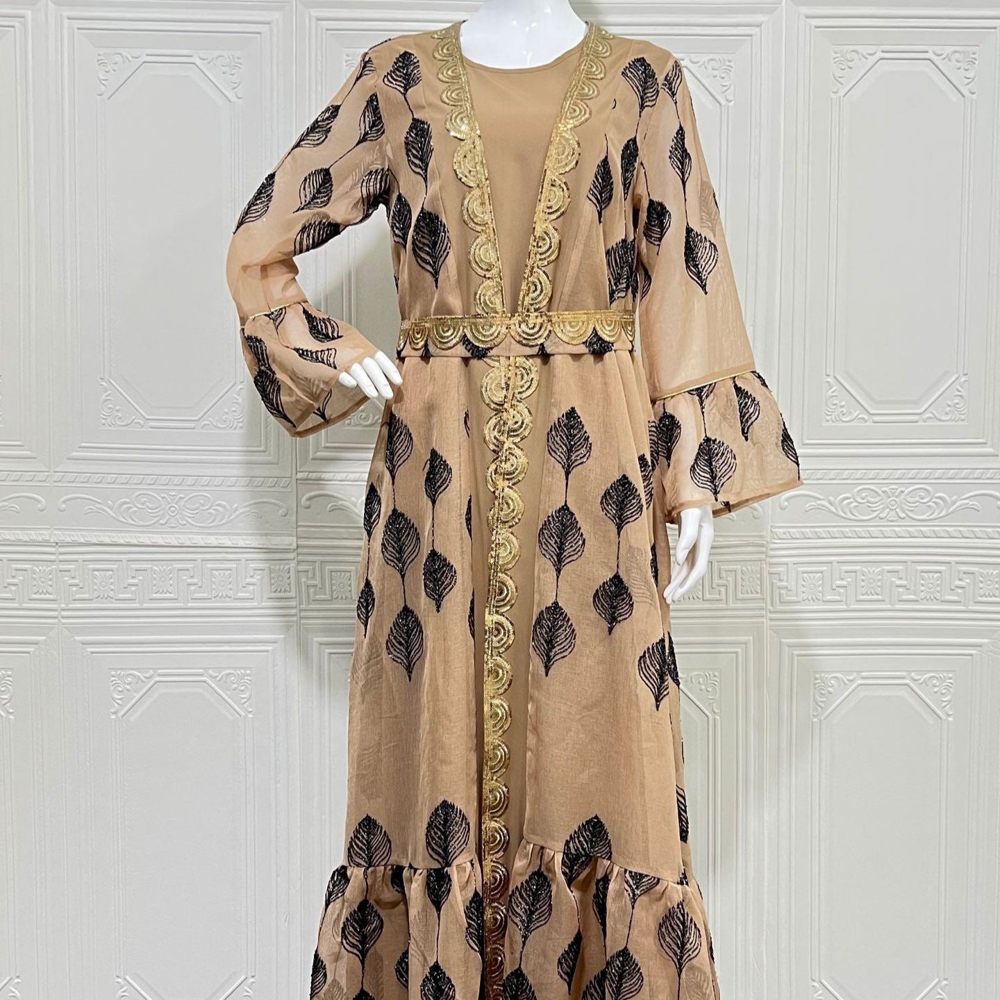Desert FYP Viral Khaleeji Two-Piece Modest Co-ord Warm Sand Tone Light Woven Outer Kaftan Matching Solid Slip Dress All Over Vintage Black Leaf Print Handcrafted Golden Lace Trim Placket Elastic Gold Waist Belt Bell Flared Tiered Long Sleeve Ruffled