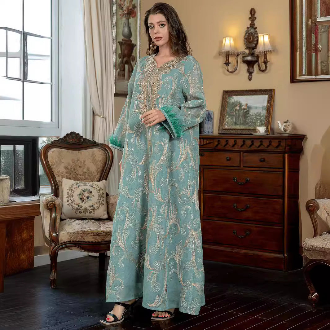 Turquoise Premium Arabian Craft Sheer Modest Gown Light Airflow Semi-Sheer Textile All Over Delicate Pale Gold Thread Embroidery Classic V-Neckline Loose Full-Length Silhouette Voluminous Bell Sleeves Pan-Arab Ladies Attire For Elegant Evening Gather