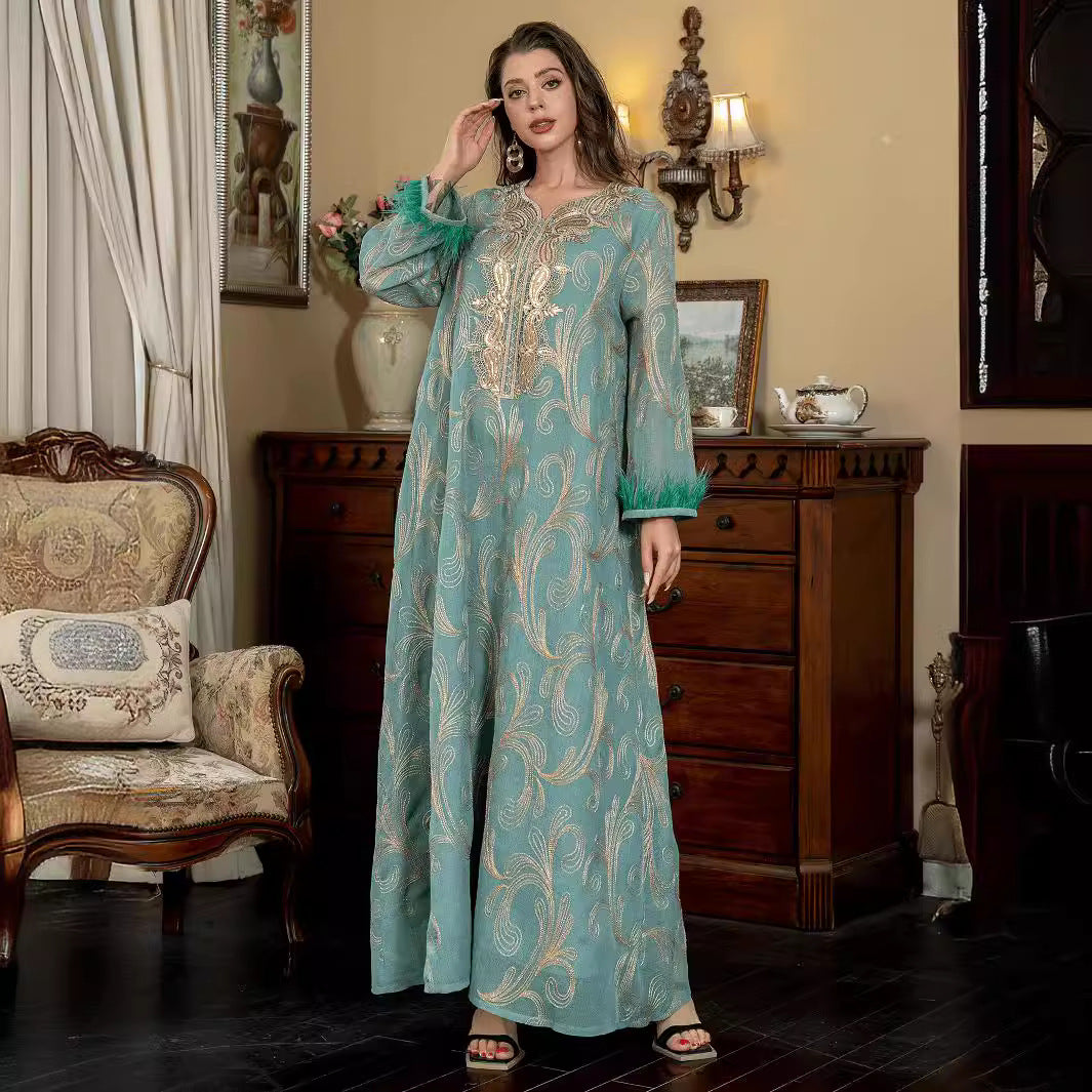 Turquoise Premium Arabian Craft Sheer Modest Gown Light Airflow Semi-Sheer Textile All Over Delicate Pale Gold Thread Embroidery Classic V-Neckline Loose Full-Length Silhouette Voluminous Bell Sleeves Pan-Arab Ladies Attire For Elegant Evening Gather